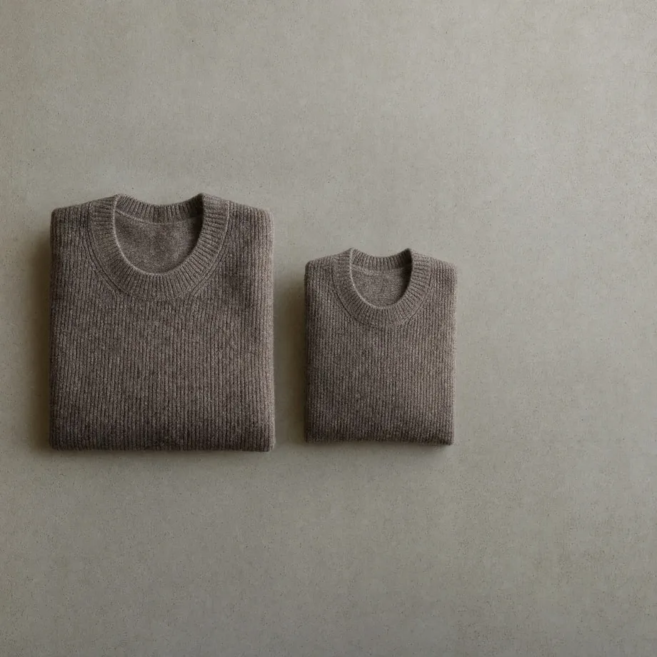 Two identical garments in different sizes laid side by side for comparison.